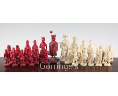 A 19th century Macau carved and stained ivory chess set, carved as Europeans opposing Chinese, king 4.75in.