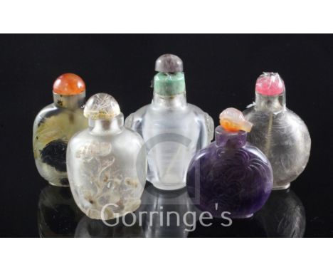 Five Chinese quartz snuff bottles, late 19th / 20th century, the first in smoky quartz well hollowed and engraved with a drag