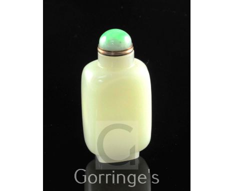 A Chinese pale celadon jade snuff bottle, 1800-1900, of oblong form, well hollowed on an oblong shaped foot, gilt metal and j