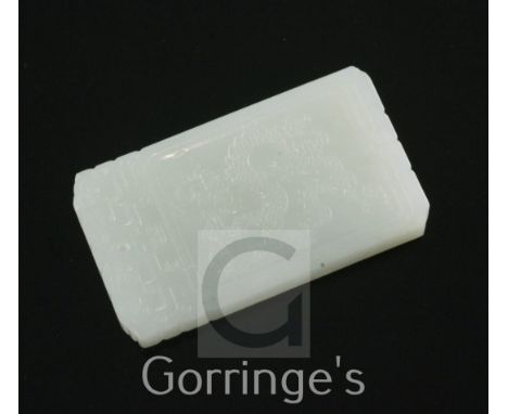 A Chinese pale celadon jade plaque, carved in relief to one side with a dragon, the other with calligraphic inscription, 5.7c
