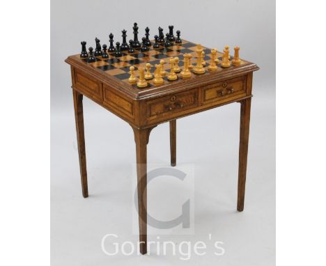 An early 20th century French inlaid oak chess table, with Jaques style chessmen, kings 4.5in.