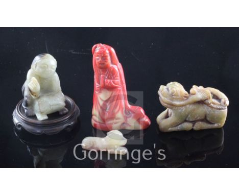 Two Chinese jade figures, a bowenite figure and a coral figure, the first of celadon black jade carved as Liu Hai and his thr