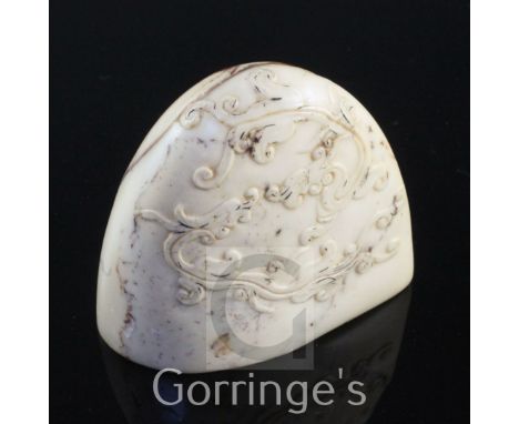 A Chinese cream and red soapstone seal, carved in low relief with chi-dragons, 6.3cm