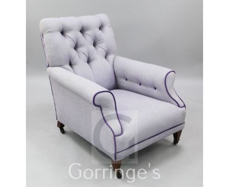 An Edwardian violet tweed upholstered button back armchair, on mahogany square tapering legs and ceramic castors