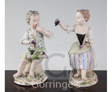 Two Meissen figures of grapepickers, 19th century, each seated on a basket, the boy Marcolini period, the girl mid 19th centu