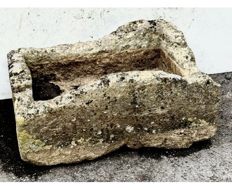 A large, well weathered carved limestone garden trough - with an unevenly shaped rim, approx. dimensions 78 x 56.5cm, max hei
