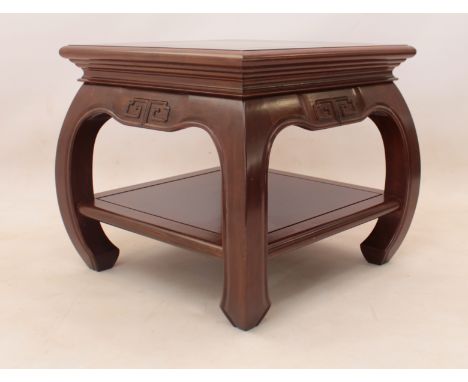 A Chinese hardwood two-tier occasional or lamp table, to match lot 454 - the cleated top over a shaped frieze with carved key