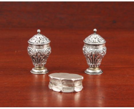 A pair of Victorian silver pepperettes and a pill box - the pepperettes Henry Wilkinson &amp; Co., Sheffield 1881, 4.9cm high