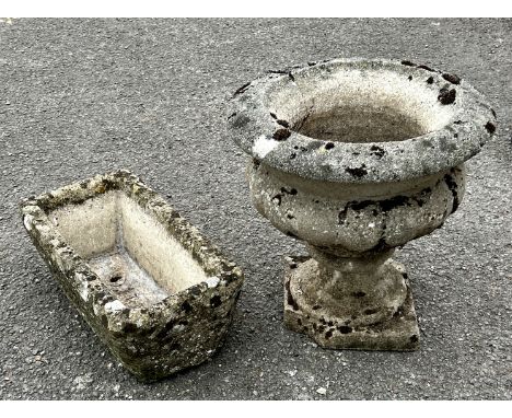 Two pieces of reconstituted stoneware, comprising - 1. an urn - 41.5cm diameter, 42.5cm high; 2. a trough planter - (LWH 44 x