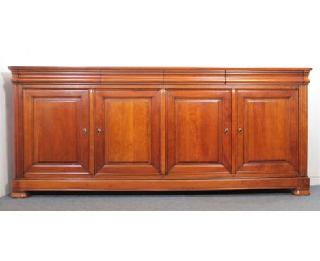 A large cherrywood buffet or sideboard by Wesley Barrell of Witney - the cleated, moulded top over four flush ogee frieze dra