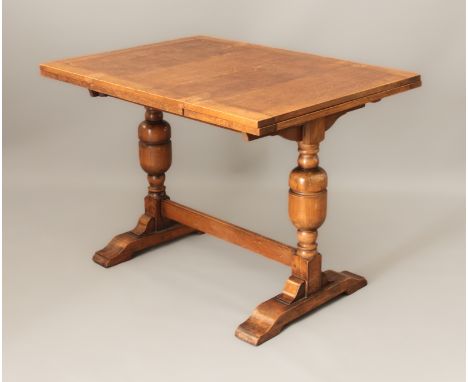 A beech and oak draw-leaf refectory style dining table - mid-20th century, the cleated top raised turned supports with sledge
