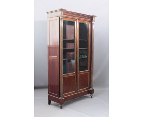 A late 19th century French mahogany and brass vitrine bookcase - the brass mounted top and frieze with outset corners on flut