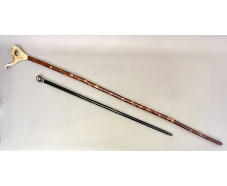 Two walking canes / sticks - comprising an early 20th century silver-mounted ebonised walking cane - the silver knop hallmark