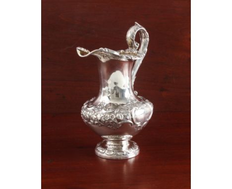 A William IV Scottish silver milk jug - William Marshall, Edinburgh 1837, baluster form with repouss&eacute; floral, foliate 