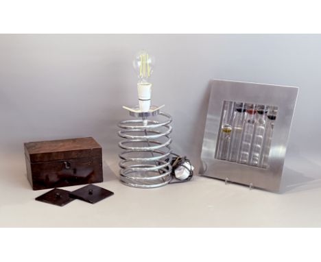 Three pieces, comprising - 1. A stainless steel and glass wall hanging Galileo thermometer 2. A vintage chrome 'spring' table