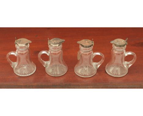 A set of four whisky tots - silver mounted, Hukin &amp; Heath, Birmingham 1928, one with conforming silver Whiskey label.