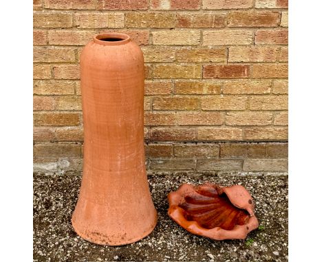 A terracotta rhubarb forcer - of slender, elongated bell shape, 79cm high; together with a terracotta shell-shaped bird bath 