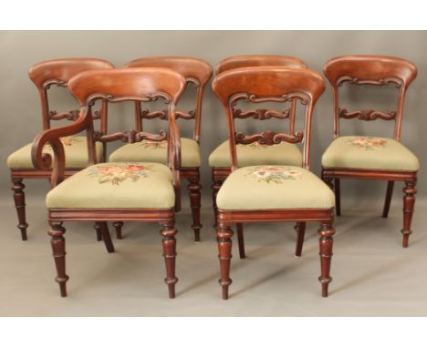 A set of six mid-19th century mahogany dining chairs - including a single carver, with deep, scroll carved top rails and foli