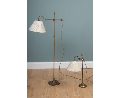 Two lamps The first a brass floor lamp with adjustable height and angled head; the second and a brushed brass adjustable desk