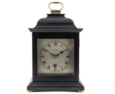A Georgian style mantel timepiece The ebonised case in the form of a Georgian bracket clock with a gilt hinged carry handle. 