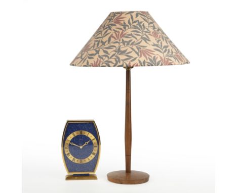 A Looping timepiece together with a Modernsist table lamp The looping timepiece in a brushed brass case of shaped form with l
