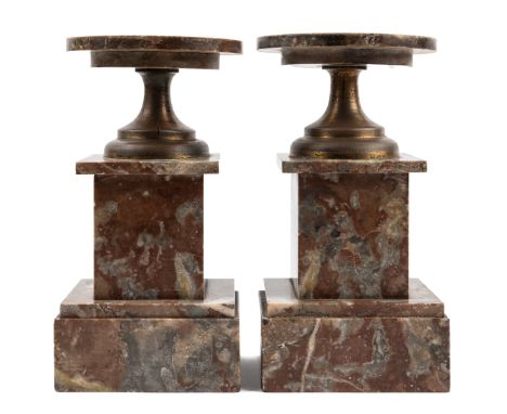 A pair of brass and marble tazzas On square plinth bases.10cm diameter x 19cm highQty: 2Some of the marble on the bases has b