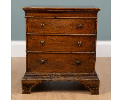 An 19th century elm commode chest With three drawers and carry handles, raised on bracket feet.49cm wide x 41cm deep x 56cm h