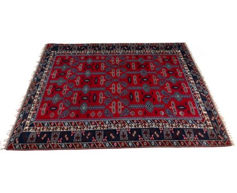 A mid to late 20th century red and blue ground carpet With a multiple banded border and geometric decoration.260cm x 350cmQty