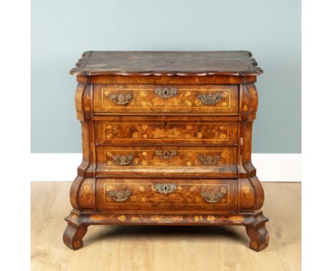 A late 18th century Dutch marquetry walnut commode With a shaped top, four drawers with brass handles, and scroll feet.87cm w