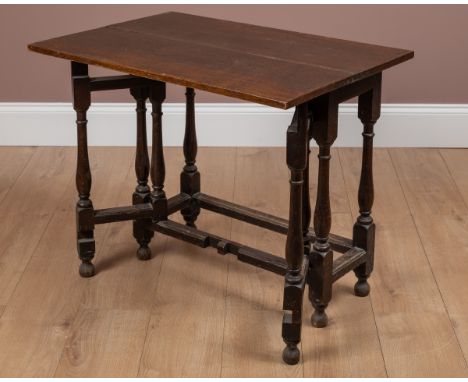 A small 17th or 18th century oak fold-over gateleg table With turned legs and feet.81cm wide x 28cm deep (56cm unfolded) x 72