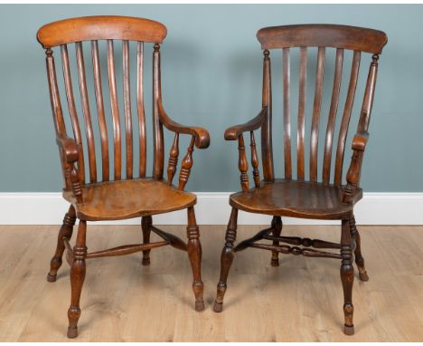 Two similar lath-back Windsor armchairs Each chair with a comb-top, scrolling arms with turned supports, carved saddle seats 