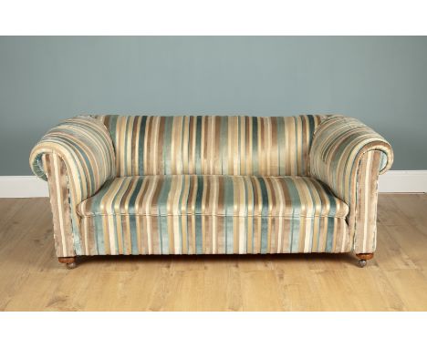 An Edwardian Chesterfield sofa The sofa upholstered in GP &amp; J Baker Upholstery striped material, standing on bun feet and