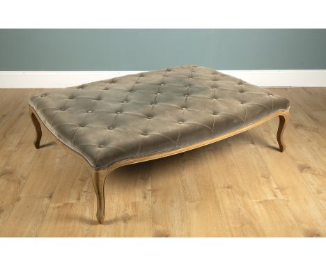 A large oak stool in the French style With a Dralon button-upholstered seat and cabriole legs.146cm long x 103cm wide x 43cm 