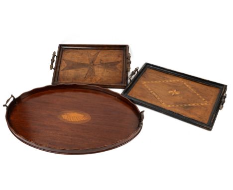 A group of three trays The first a 19th century mahogany oval tray with brass handles and shell inlay to the centre; together