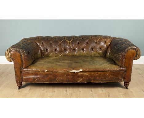 A leather button-upholstered Chesterfield sofa Raised on turned front legs with castors.195cm wide x 65cm highQty: 1Notable w