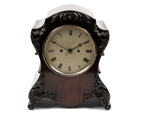 A 20th century mahogany table clock The shaped case with carved scrolling ornament around a Roman painted dial signed 'J Morr