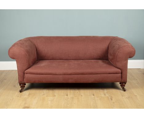 A mahogany framed brown upholstered Chesterfield sofa With turned front legs raised on castors.181cm wide x 72cm high x 82cm 