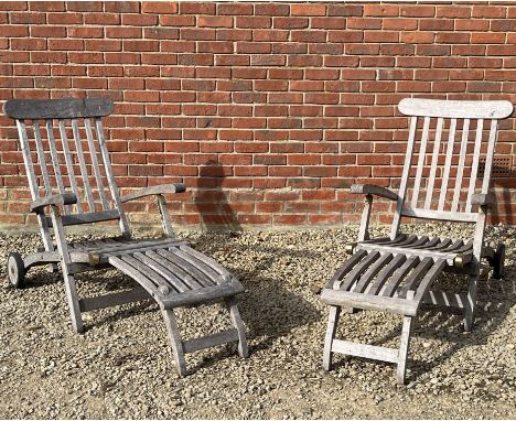A pair of teak steamer chairs With metal mounts and castors to the back legs.61cm wide x 88cm high x approximately 175cm (lon