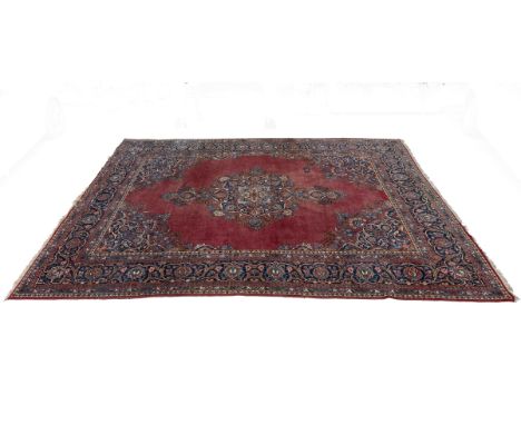 A 20th century machine woven Kashan carpet The central medallion on a magenta ground, with offcut corners and a guarded borde