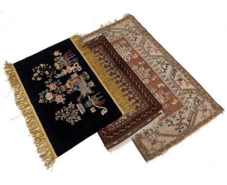 A collection of three rugs A Chinese blue silk ground pictorial rug with a Bonsai tree motif, 150cm x 100mm; a Belouch camel 
