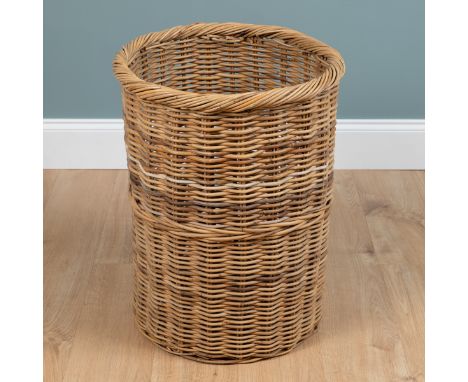 A large wicker log basket Of cylindrical form.51cm diameter x 56cm highQty: 1Ing generally good condition with light wear com