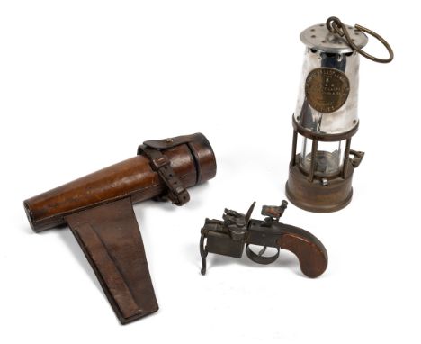 A Dunhill "tinder" lighter together with a glass flask and a miner's lamp The lighter in the form of a Georgian "tinder" ligh