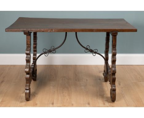 A late 18th century Spanish fruitwood table The shaped lyre legs united by metalwork stretchers.128cm wide x 69cm deep x 79cm