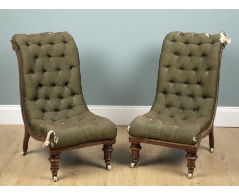 A pair of 19th century mahogany and inlay framed slipper chairs With green buttoned upholstery and raised on brass caps and c