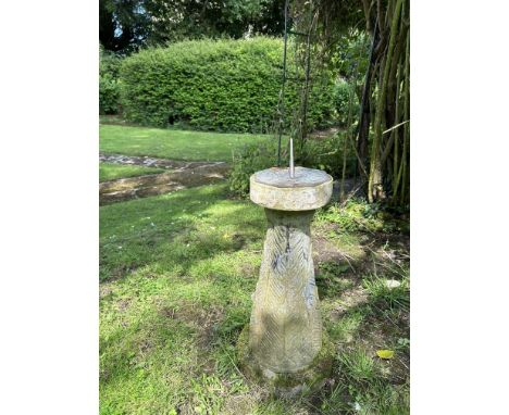 A small cast reconstituted stone sundial With a bronze dial plate and feather ornamented support.30cm diameter at the base x 