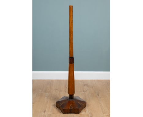An Art Deco walnut standard lamp With a hexagonal inlaid base.140cm highQty: 1In reasonable condition but signs of some old r