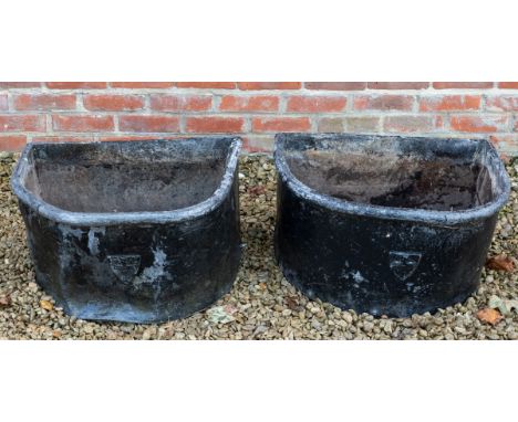 A pair of 'D' shaped lead planters Each black painted planter with an emblem to the front for The Golden Cross, Oxford.63cm w