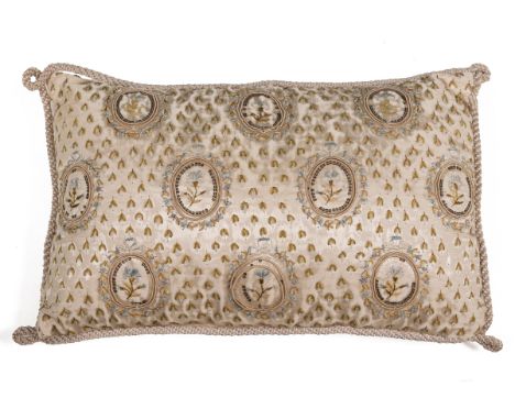 A Regency silk cushion Worked on an ivory silk ground with studies of flowers in roundels worked in coloured silks with a sil