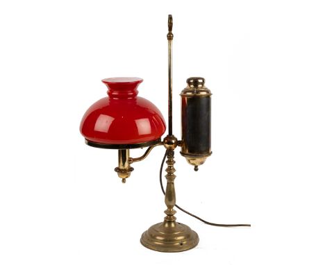 An antique brass adjustable desk light With a red shade.57.5cm high.Qty: 1Converted to electricity. Untested.