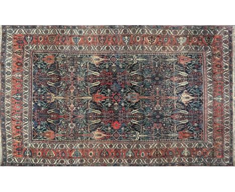 A Bijar carpet With a red and blue ground, multiple banded border and stylised geometric decoration.277cm x 437cmQty: 1In mod